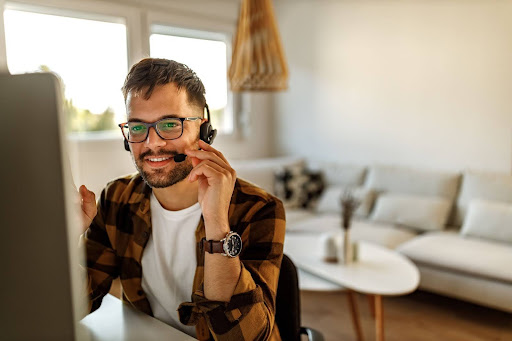 A homeshore call center agent answers a call from a remote work setup.