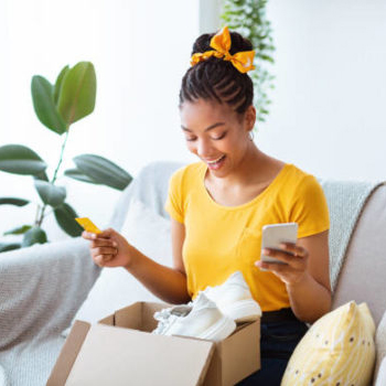 woman pulling makeup out of cardboard box