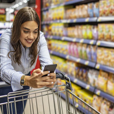 woman on phone in grocery store