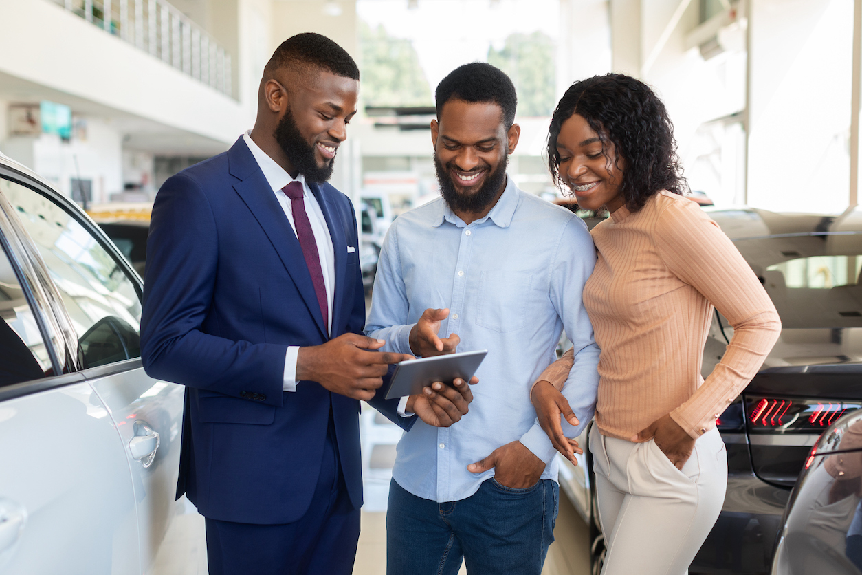 car salesman learning how to improve customer satisfaction while working in a showroom