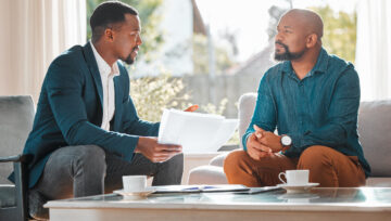 colleagues discussing ways to improve customer experience while sitting on a couch