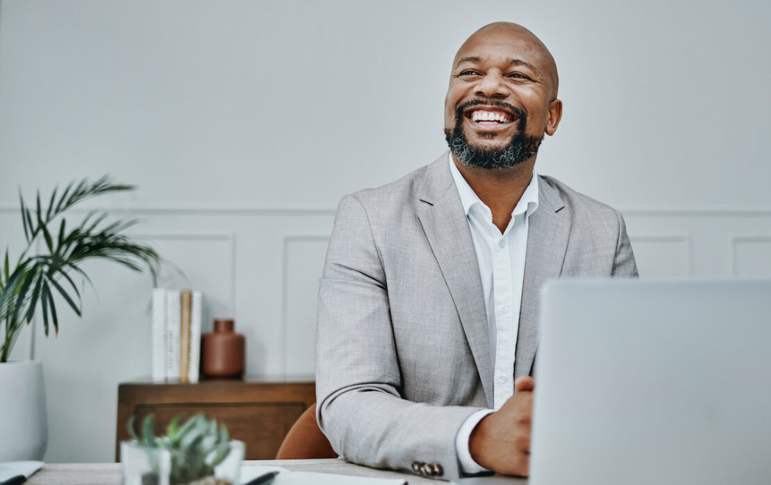 business person sitting in front of their computer reviewing customer service kpis and metrics