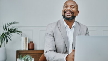 business person sitting in front of their computer reviewing customer service kpis and metrics