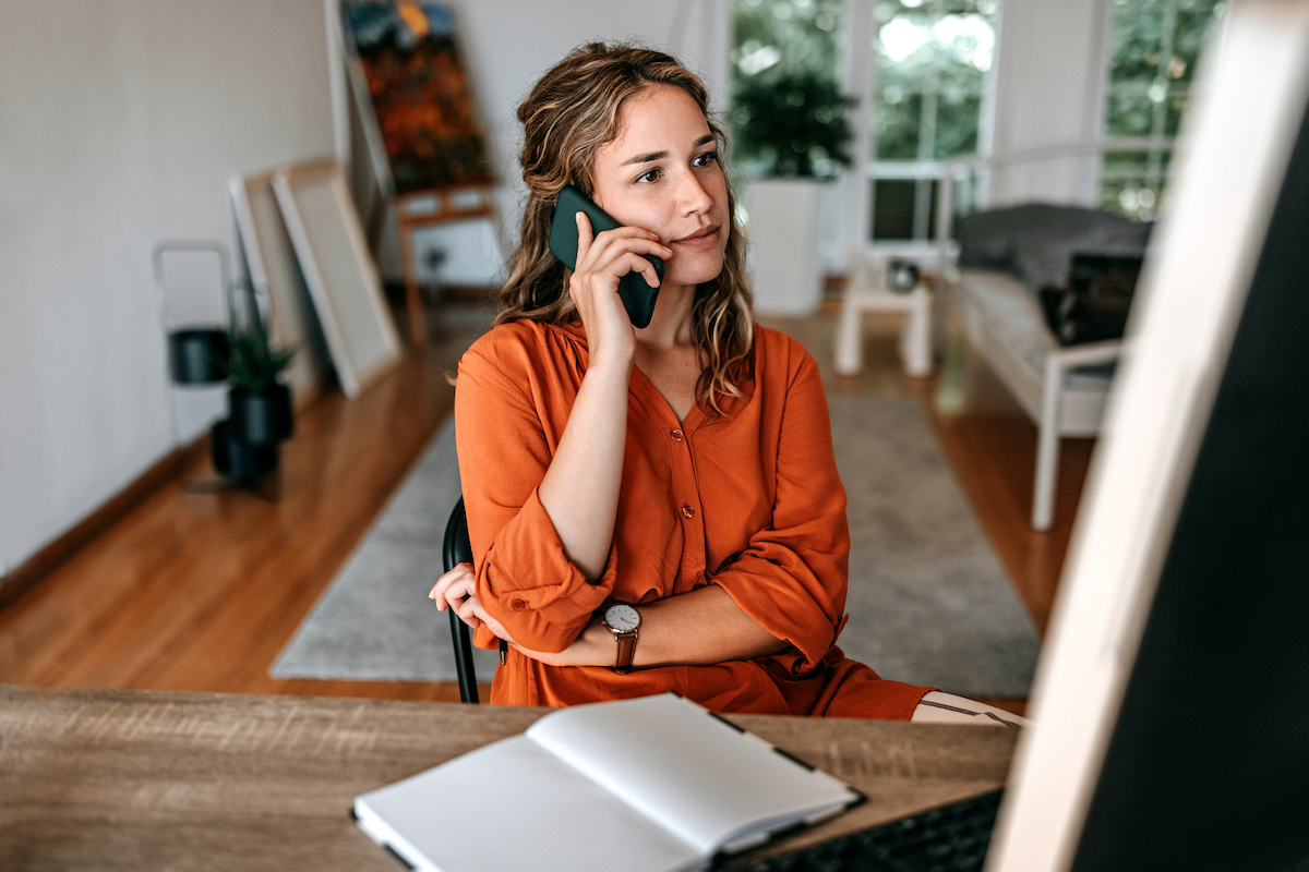 a nearshoring agent talking on a mobile phone while working remotely