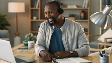 a person at their computer researching workforce management in a call center