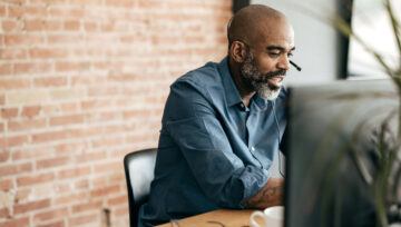 a business owner at their computer researching call center hiring problems