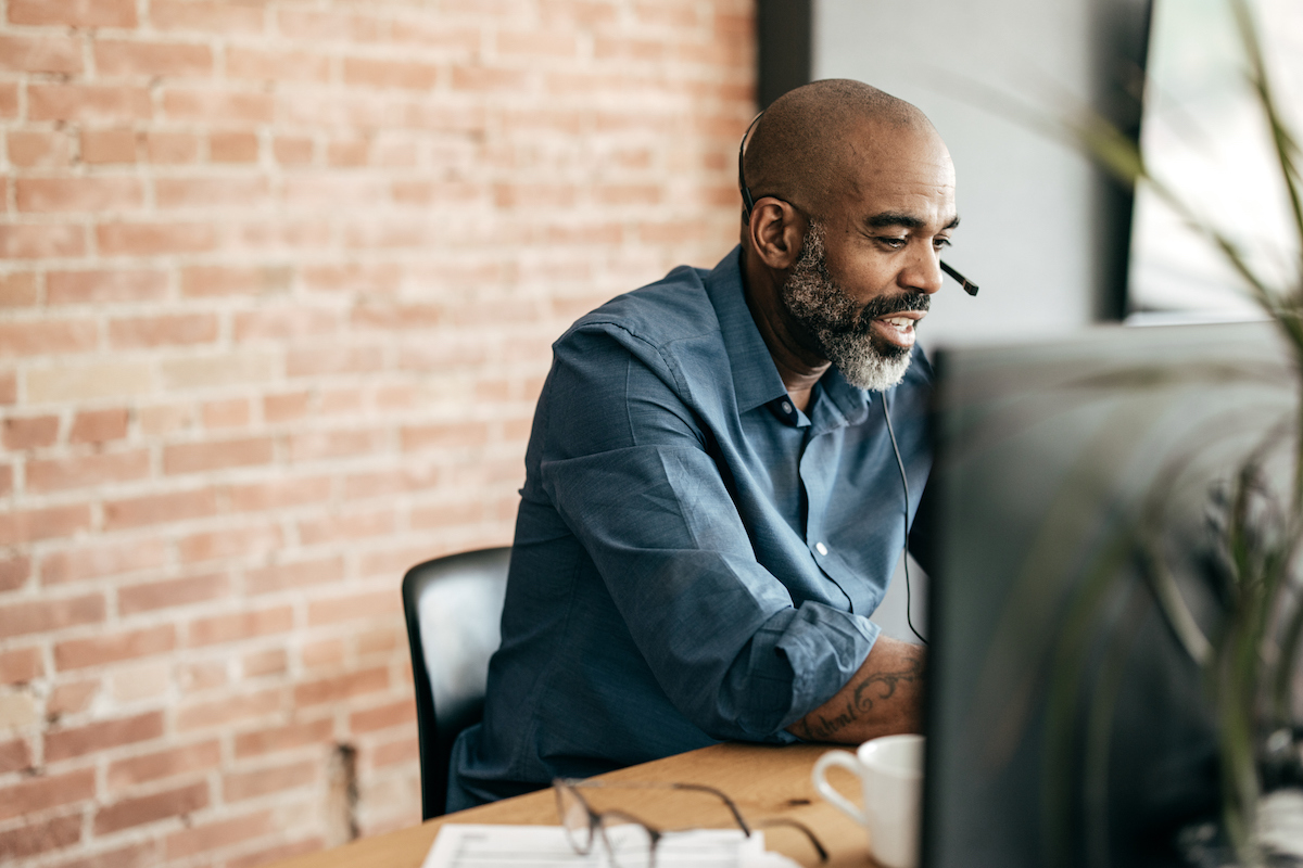 a business owner at their computer researching call center hiring problems