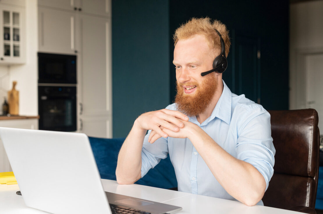 an Outsourced Call Center agent working at their computer