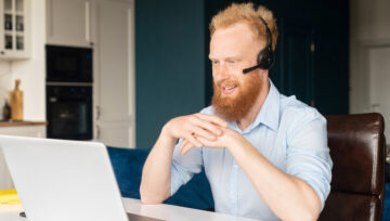 an Outsourced Call Center agent working at their computer