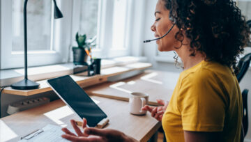 a call center agent practicing their call center etiquette.