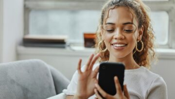 a customer service provider working from home, looking at their mobile device