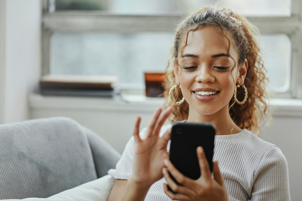 a customer service provider working from home, looking at their mobile device