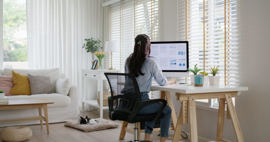 a business owner researching the latest outsourcing trends while working from home