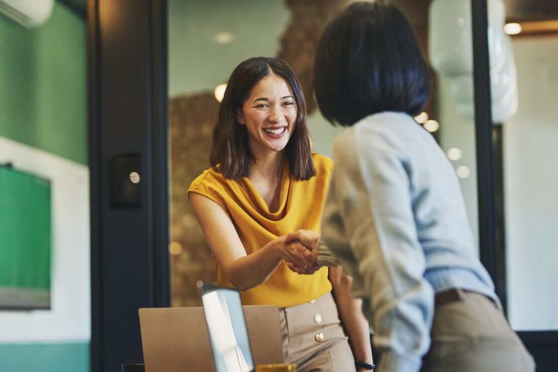 colleagues shaking hands after discussing BPO vendor management strategies