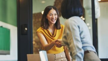 colleagues shaking hands after discussing BPO vendor management strategies