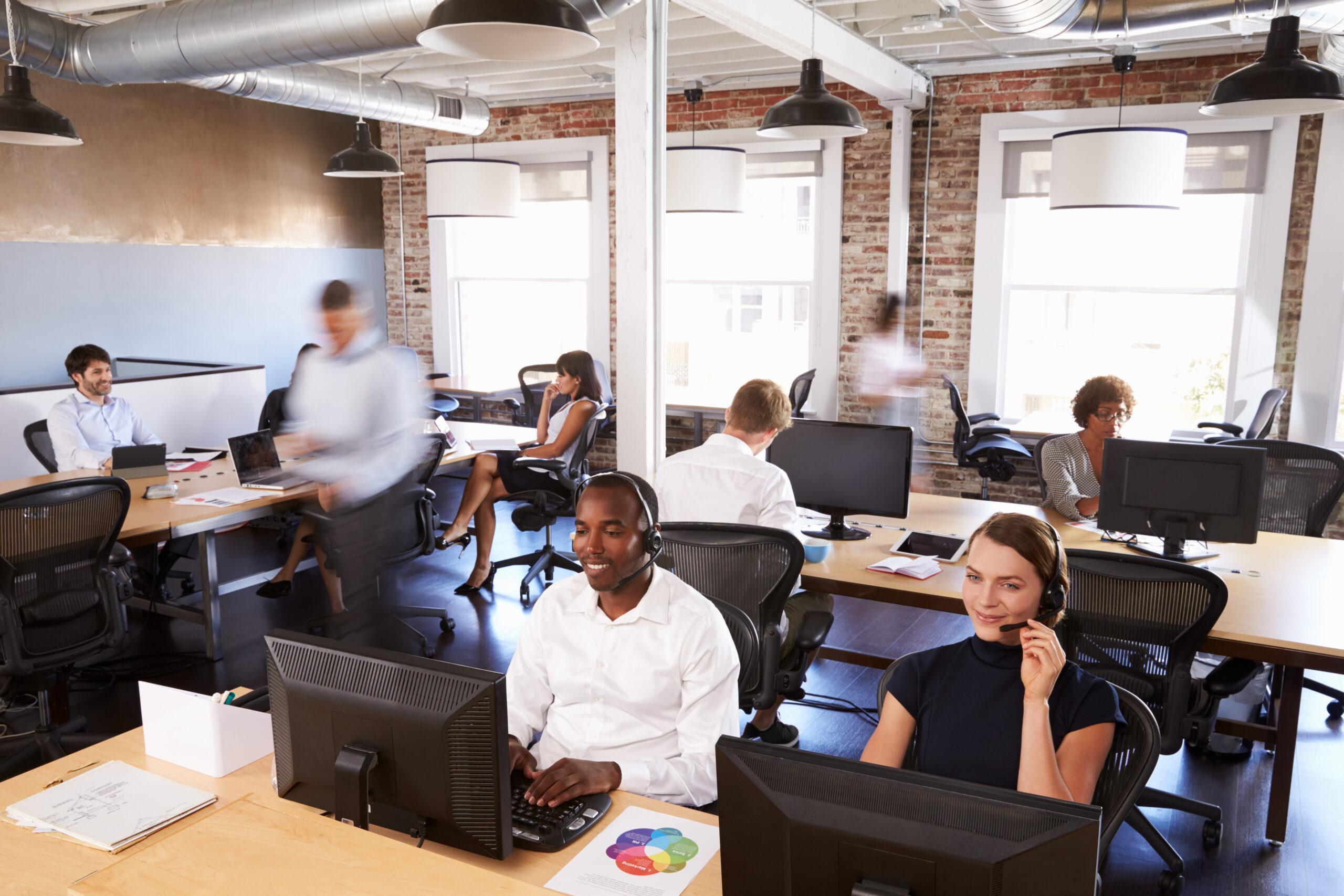 A group of busy workers on the phone in the office