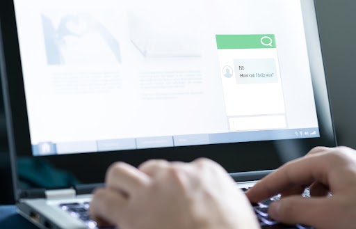 Close-up of a computer with an automated customer support chatbot.