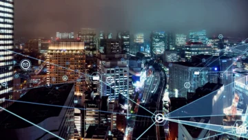 Buildings in an evening city are connected with a web of outsourced call center communication channels.