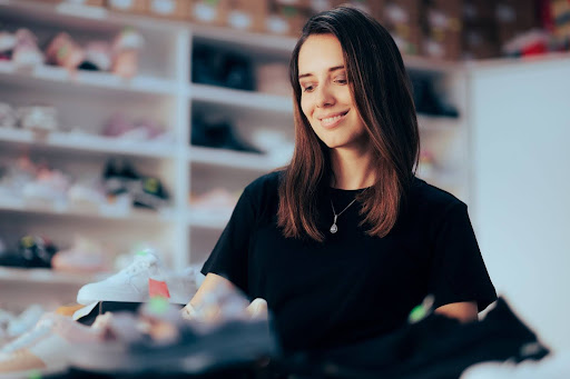 A customer looking at a variety of shoes.