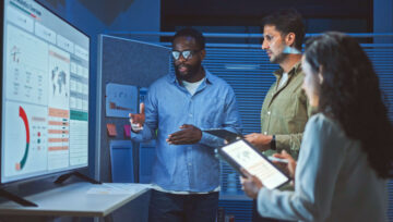 Group of people looking at analytics dashboard on a computer screen