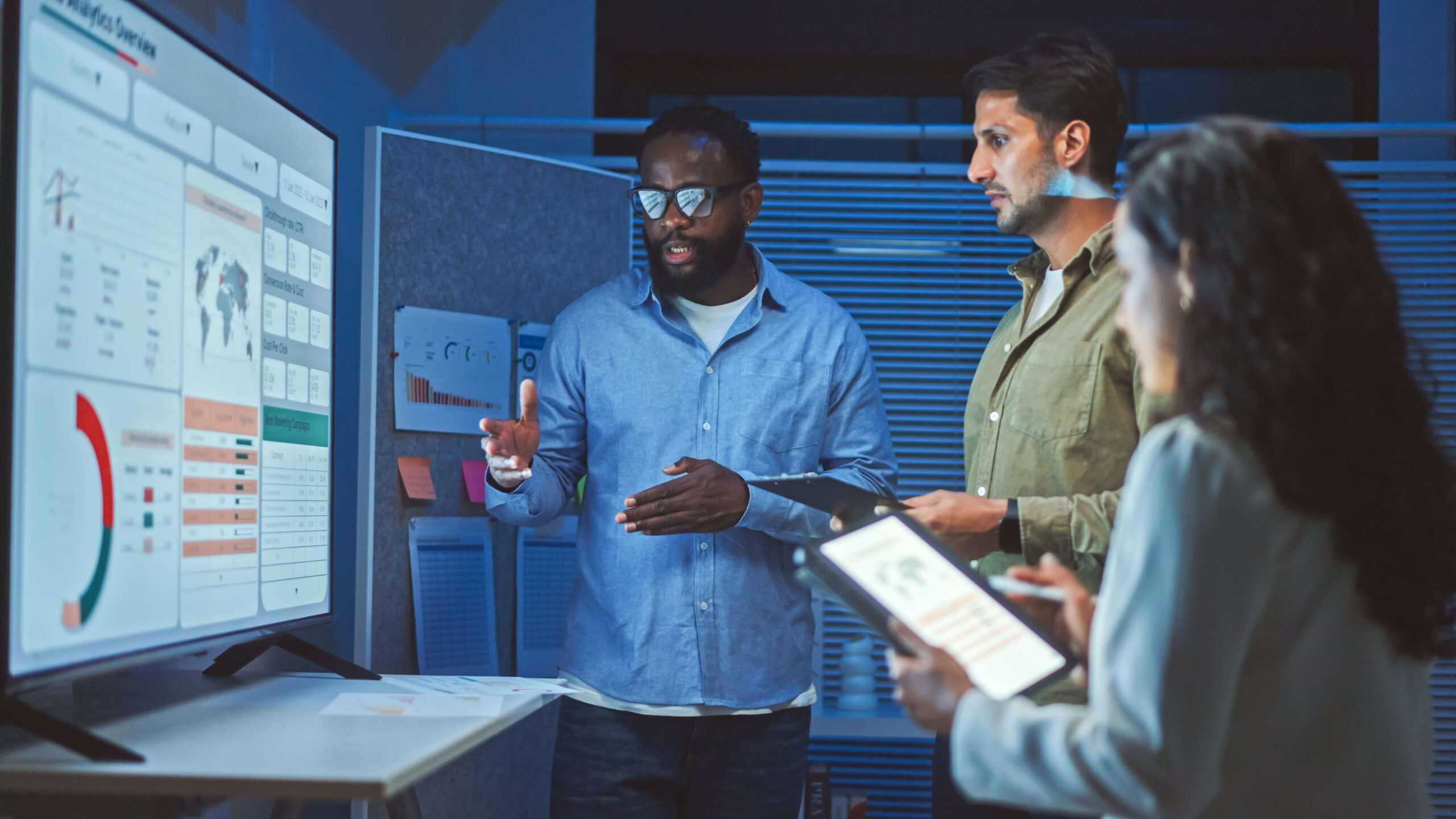 Group of people looking at analytics dashboard on a computer screen