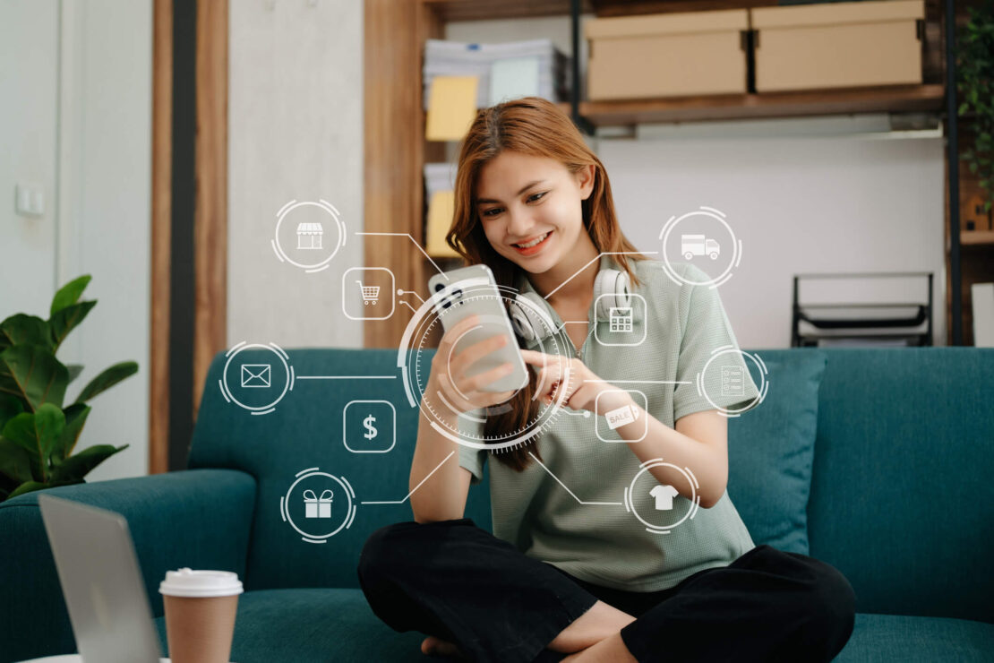 woman looking at her phone with floating icons smiling because of great customer experience