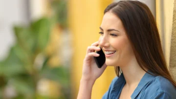young woman smiling while talking on her cell phone
