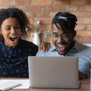 two people excited with laptop
