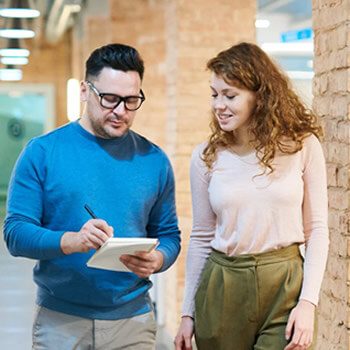 2 colleagues discussing the benefits of call center outsourcing